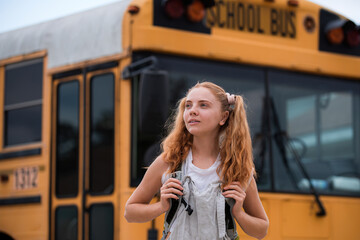 Teenager girl School concept. Smiling Student girl Ready To Board Bus.