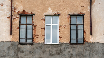 Fototapeta na wymiar The facade of old building with windows.