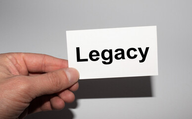 Message on the card LEGACY, in hands of businessman.