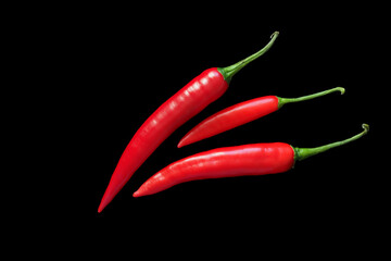 Red chili peppers on a completely black background