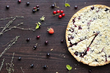 Homemade pie with berries on wooden table texture. Summer photo receipts