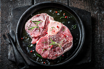 Top view of beef with rosemary ready to grill
