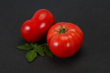Ripe tomato over wooden background