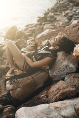 Woman with braids in egyotian style posing at the beach