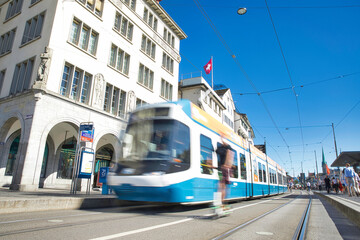 Motion Blur from Zurich, Switzerland - Hustling and moving city life in Zurich, dynamic shot of a tram and cyclists - obrazy, fototapety, plakaty