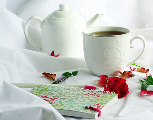 Still life with white dishes and rose petals