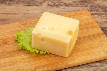 Emmental cheese over wooden board