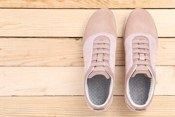 sneakers on wooden background with copy space. Top view. Vintage effect.