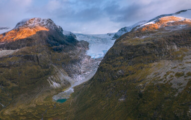 Sunset mountains and lake landscape in Norway aerial view travel in wilderness Jostedalsbreen glacier national park.