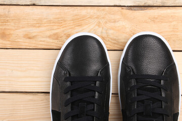 sneakers on wooden background with copy space. Top view. Vintage effect.