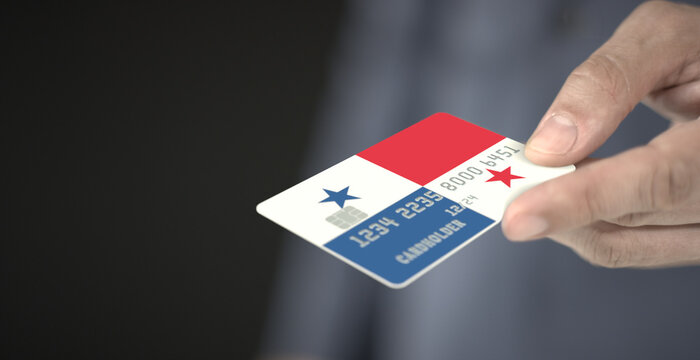 Man gives plastic bank card with printed flag of Panama. Fictional numbers - Powered by Adobe