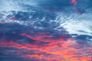 Fototapeta premium Dramatic clouds at sunset after a storm with orange and purple