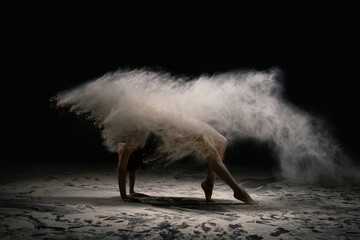 Sporty mid age woman in underwear pose in yoga asana with dust