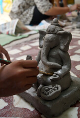 Fototapeta na wymiar Pune, India, 25 August 1019. Children classes for making Ganesh/Ganpati idol. eco friendly Ganesh/Ganpati idol or murti, home made eco Friendly Ganesha Idol for Ganapati Pooja. Vinayaka Chaviti