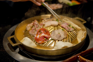 Pork grill on BBQ brass pan, focus selective