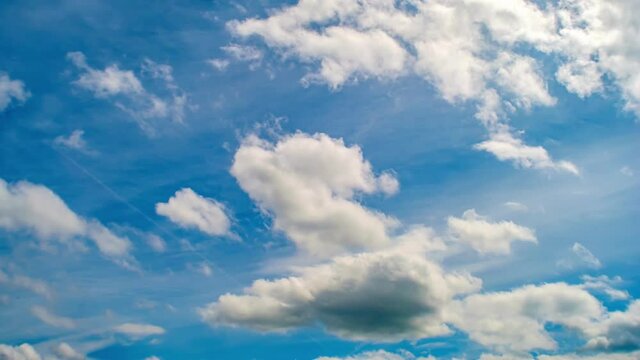 4K Loop of white clouds over blue sky time lapse