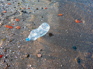 Plastic water bottle thrown on the beach