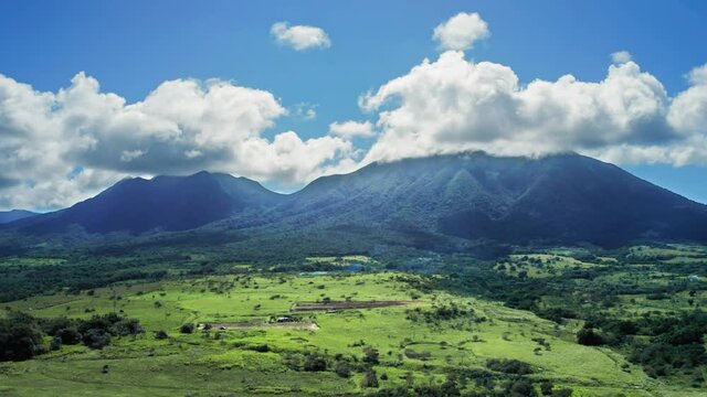 Aerial footage of Mount Liamiuga and the lower part of the island with plants in Saint Kitts and Nevis