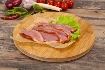 Sliced smoked duck breast served salad