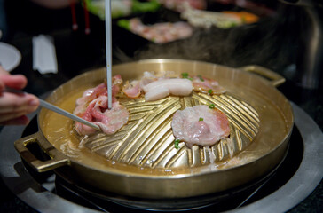Pork grill on BBQ brass pan, focus selective