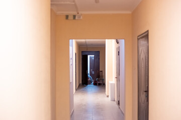 entrance of an apartment building, long corridor in pastel colors. Purchase and inspection of real estate.