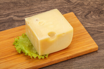 Emmental cheese over wooden board