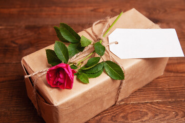 gift wrapped in craft paper on top of a flower tied with twine