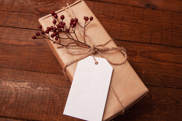 gift wrapped in craft paper on top of a flower tied with twine