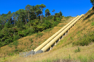 Giant pipelines on a hillside, supplying water to a hydroelectric power station. Photographed at...