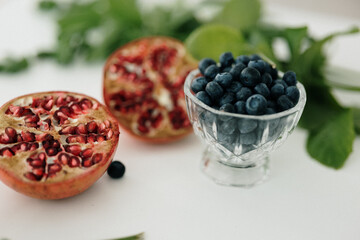 blueberries and pomegranates cut into containers
