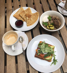 Outdoor Breakfast, bruschetta coffee salad and tourist Breakfast with beef on a wooden table