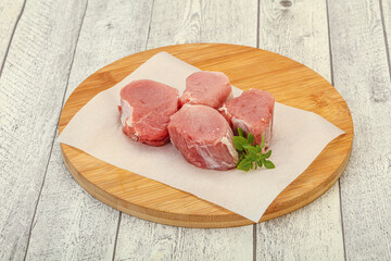 Raw pork medallion served rosemary