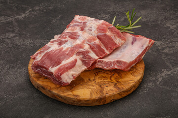 Raw pork ribs served rosemary
