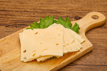 Sliced yellow cheese over board