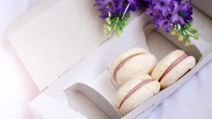 White macaroons in a cardboard box, dessert.