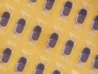 Ice cream in plastic pattern on yellow background