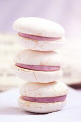 White macaroons with purple berry filling