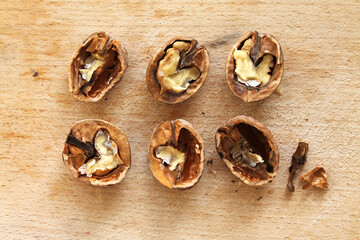 The Pieces of Crushed Nuts on the Wooden Background