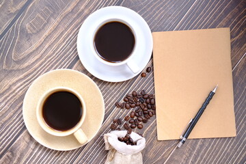 coffee cup and coffee beans on old wood table background, space for text