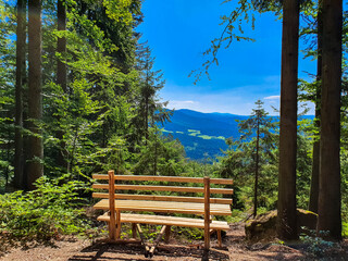 Natural viewpoint with a wooden bench in the foreground, Bavarian Forest Germany