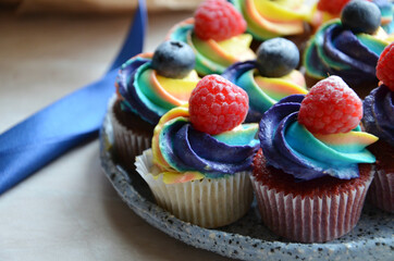 Colorful cupcakes with berries on a plate
