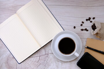 cup of coffee and coffee beans on table background