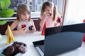 Kids virtual birthday party.Girls in dresses and caps celebrate holiday with friends on...