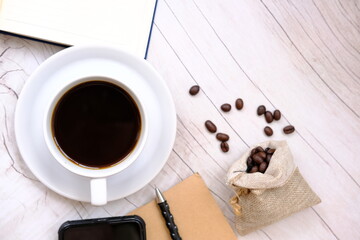 Top view coffee cup and coffee beans on old wood table background