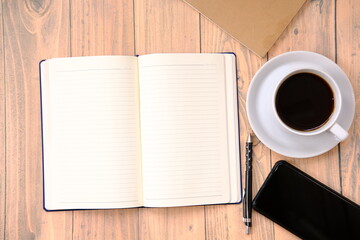 cup of coffee and coffee beans on table background