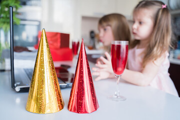Yellow,red holiday hat, glass of juice. Kids virtual birthday party.Holiday celebration at...