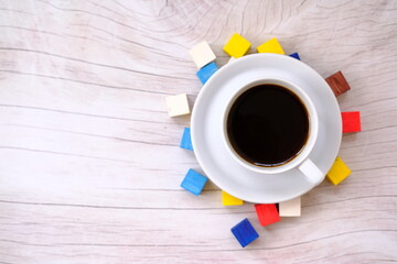 a cup of coffee on wood table and space for text