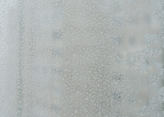 Snowflakes melting on the window, selective focus.