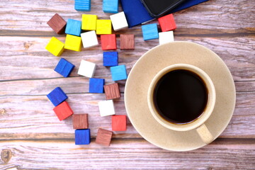 Top view cup of coffee and coffee beans on table background