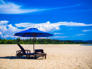 Empty deckchairs and parasols on empty beach
